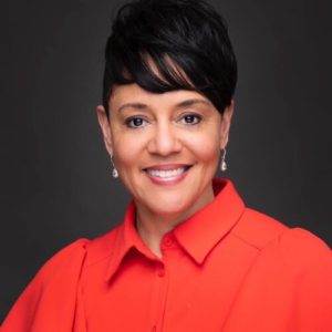 professional headshot of a smiling woman wearing a red button down shirt